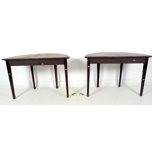 972 - A pair of George III demi lune mahogany side tables, with plain friezes, raised on square section ta... 