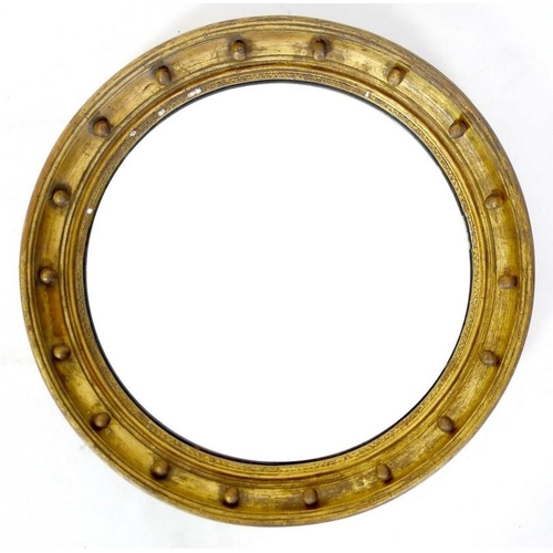 976 - A Victorian gilt framed circular wall mirror, composite gold coloured frame with applied orb decorat... 