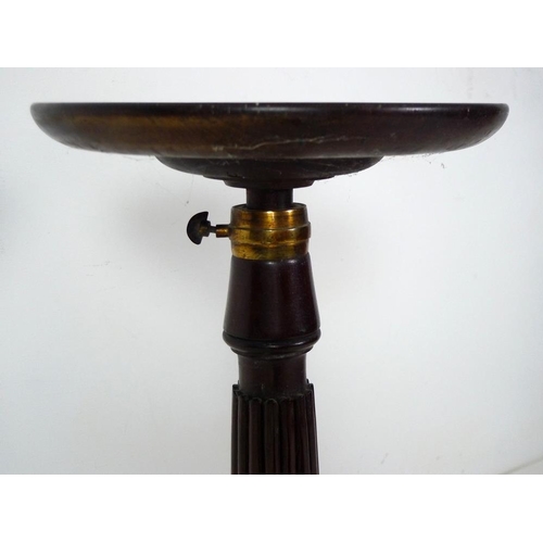 979 - An early Victorian mahogany candle stand, circular dished surface on an adjustable column with brass... 