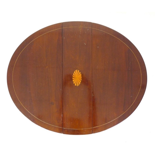 981 - An Edwardian mahogany Sutherland table, circular drop leaf surface with fan paterae and line border,... 