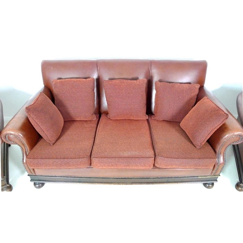 982 - A brown leather three piece suite, mid 20th century, comprising a three seater sofa, 180 by 83 by 90... 