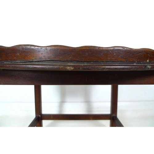 987 - A late George III mahogany tray table, large oval tray with fan patera inlay, line border, a shaped ... 