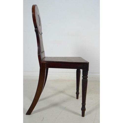 998 - A 19th century mahogany armorial hall chair, the shaped back carved and painted with the crest of th... 