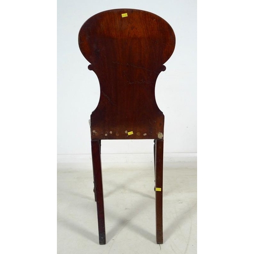 998 - A 19th century mahogany armorial hall chair, the shaped back carved and painted with the crest of th... 