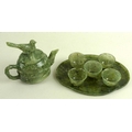 A mid to late 20th century green hardstone miniature tea set, comprising a teapot, the spout and han... 