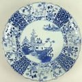 A Chinese porcelain bowl, 19th century, decorated with blue fluted sides, painted panels depicting f... 
