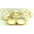 An early 19th century English porcelain part tea service, the bodies gilt decorated against a cream ... 