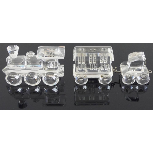 535 - A collection of Swarovski crystal miniatures, comprising train tender, 6cm, and carriage, 8cm, a spo... 