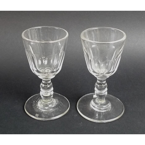 540 - A pair of Georgian dram glasses, circa 1830, each with double knopped stems and slice cut lower bowl... 