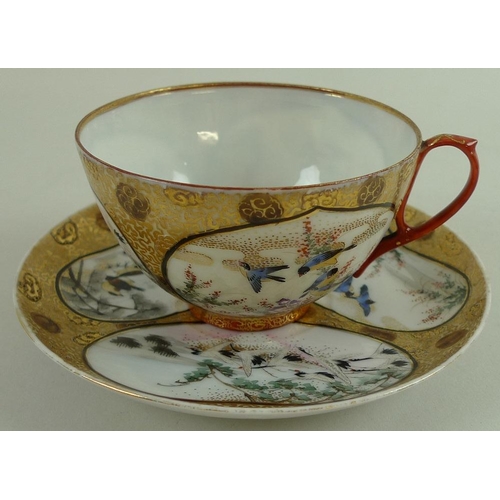 546 - A signed 19th century teacup, 11 by 5.5cm, and saucer, 12cm, the reserves decorated with birds, a Ku... 