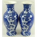 A pair of Chinese baluster vases, late 20th century, decorated with prunus blossom on a blue cracked... 