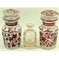 A pair of Continental glass faceted jars and covers, late 19th century, decorated in dark red with s... 