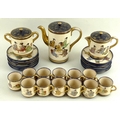 A Japanese pottery part tea service, early 20th century, decorated with geishas with blue and gold r... 