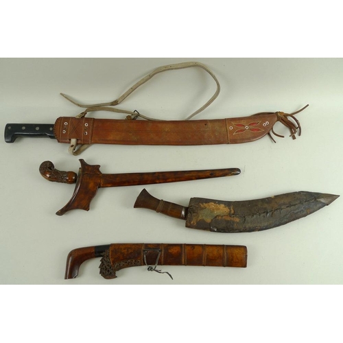 633 - An Indonesian Makassar Badik, together with a Malaysian Kris with intricately carved handle and unus... 