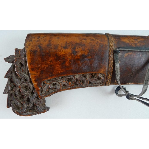 633 - An Indonesian Makassar Badik, together with a Malaysian Kris with intricately carved handle and unus... 