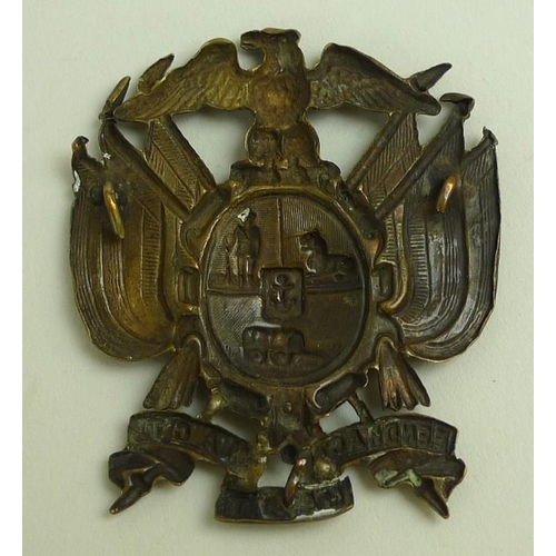 648 - A Boer War cap badge, circa 1890's, cast brass with eagle surmounting a crested cartouche, flanked b... 