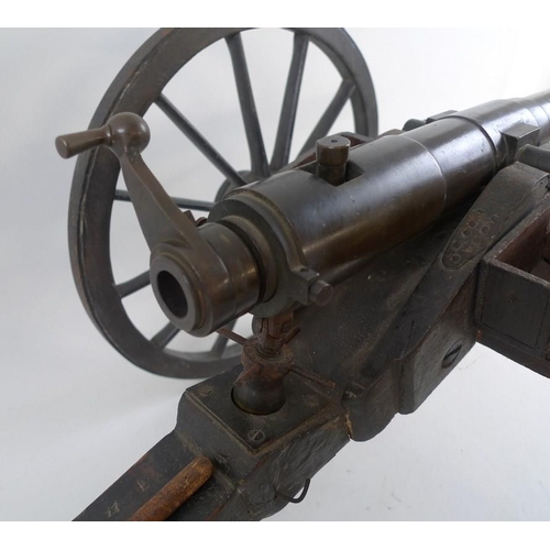 664 - A miniature artillery field gun, early 20th century, consisting of a patinated bronze barrel, with r... 