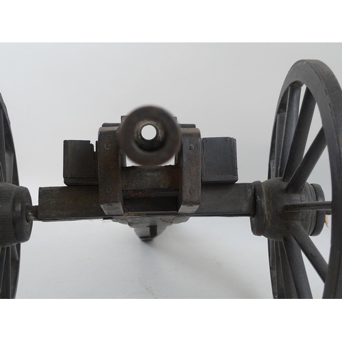 664 - A miniature artillery field gun, early 20th century, consisting of a patinated bronze barrel, with r... 