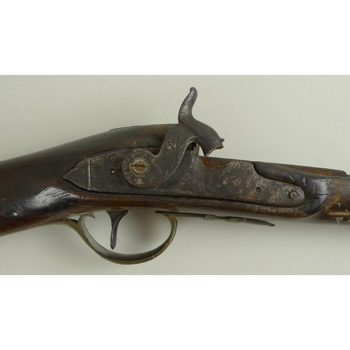 675 - An early 19th century percussion shotgun, with octagonal breech, damascus barrels, and brass trigger... 