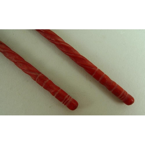 682 - A pair of Chinese flame coral chopsticks, 19th century, carved with spiral twist grips, 20.5cm, in a... 