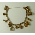 A 9ct gold double curb link charm bracelet, complete with thirteen 9ct gold charms, 19.4g total weig... 