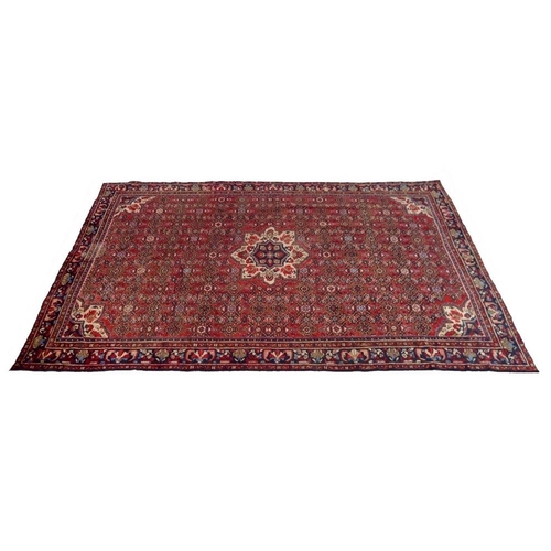 928 - A Hamadan rug with red ground and detailed field, central cream pendant and small corners, multiple ... 