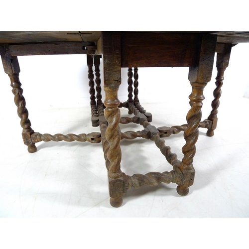 931 - An early 18th century oak drop leaf dining table with barley twist gate legs, 157 by 57.5 by 74cm hi... 