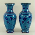 A pair of Iznik earthenware baluster vases, the bodies painted with cobalt flowers on a turquoise gr... 