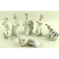 A collection of Lladro figures, comprising Bashful Bather Girl washing Dog, model no. 5455 , 12cm, a... 
