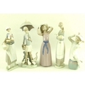 A collection of Lladro figures, comprising a girl in a mauve dress and hat, model no. 5011, 25cm, a ... 