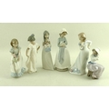 A group of Nao figurines, comprising a standing girl in a sweeping dress with butterfly, 23.5cm, a g... 