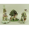 A group of 19th century Continental porcelain figurines, comprising a seated stag backed with floral... 
