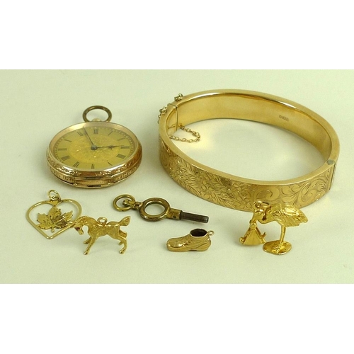 891 - A collection of gold items, comprising a 9ct gold bangle foliate engraved, complete with safety chai... 