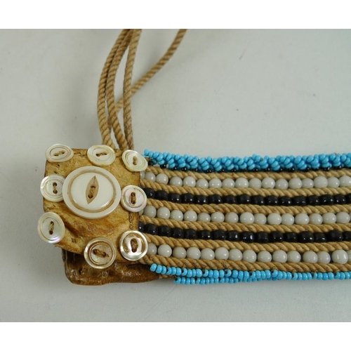 897 - An mid 20th century South African waist band, formed of a plaited band with turquoise and black bead... 