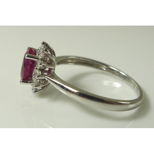 899 - A 9ct white gold, diamond and vibrant pink tourmaline ring, the central oval cut tourmaline of 7 by ... 