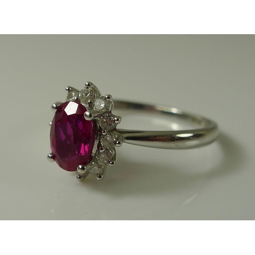 899 - A 9ct white gold, diamond and vibrant pink tourmaline ring, the central oval cut tourmaline of 7 by ... 