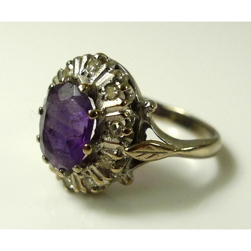 918 - An 18ct white gold, amethyst and diamond dress ring, the central amethyst of approximately 8.2 by 6.... 