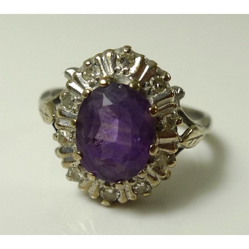 918 - An 18ct white gold, amethyst and diamond dress ring, the central amethyst of approximately 8.2 by 6.... 