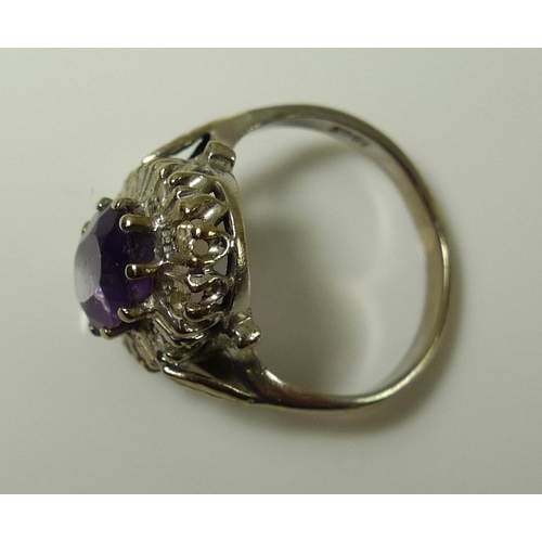 918 - An 18ct white gold, amethyst and diamond dress ring, the central amethyst of approximately 8.2 by 6.... 