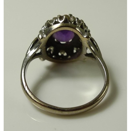 918 - An 18ct white gold, amethyst and diamond dress ring, the central amethyst of approximately 8.2 by 6.... 