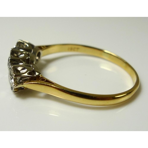 921 - An 18ct gold and three stone diamond ring, the stones illusion set, largest central 4mm diameter, 0.... 