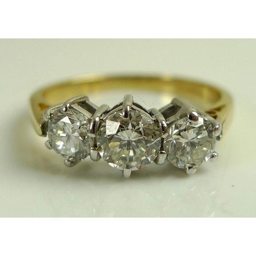 924 - An 18ct gold and diamond three stone ring, the central diamond of approximately 0.5ct, flanked by tw... 