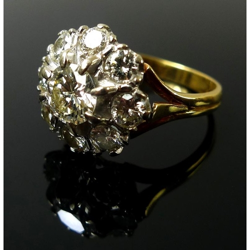 939 - An 18ct gold and diamond dress ring, the cluster setting with central diamond of approximately 1.ct,... 