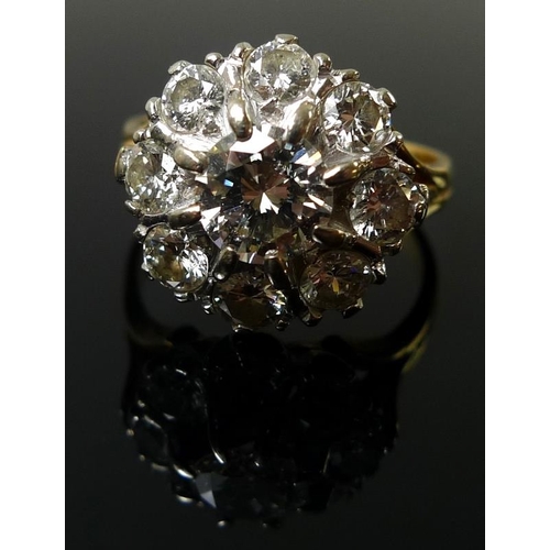 939 - An 18ct gold and diamond dress ring, the cluster setting with central diamond of approximately 1.ct,... 