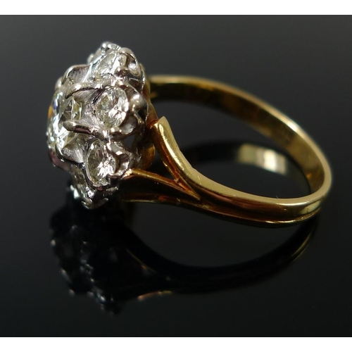 939 - An 18ct gold and diamond dress ring, the cluster setting with central diamond of approximately 1.ct,... 