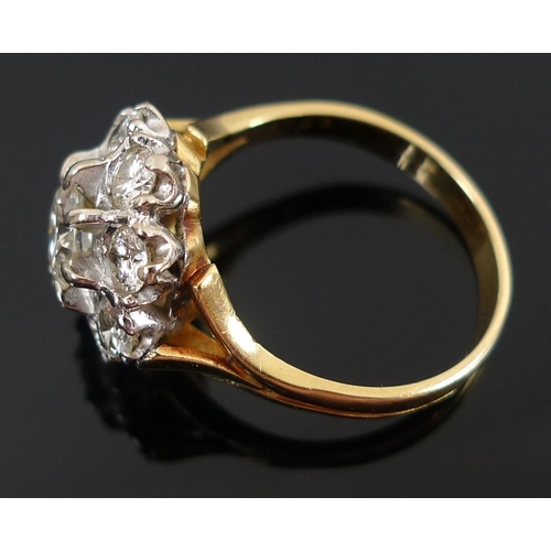 939 - An 18ct gold and diamond dress ring, the cluster setting with central diamond of approximately 1.ct,... 