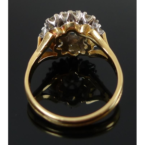 939 - An 18ct gold and diamond dress ring, the cluster setting with central diamond of approximately 1.ct,... 