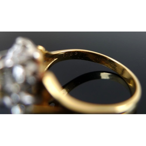 939 - An 18ct gold and diamond dress ring, the cluster setting with central diamond of approximately 1.ct,... 