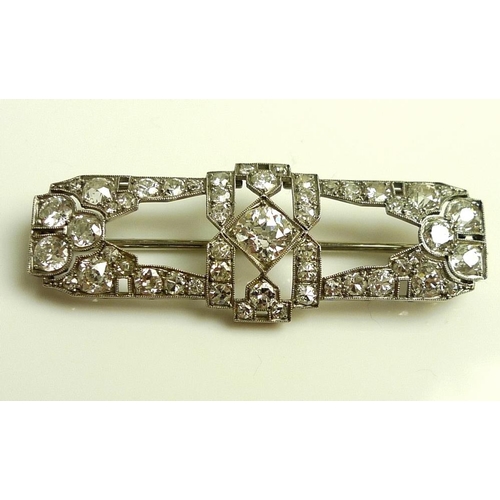 940 - An Art Deco diamond brooch, of stylised geometric design, the central diamond of approximately 0.75c... 