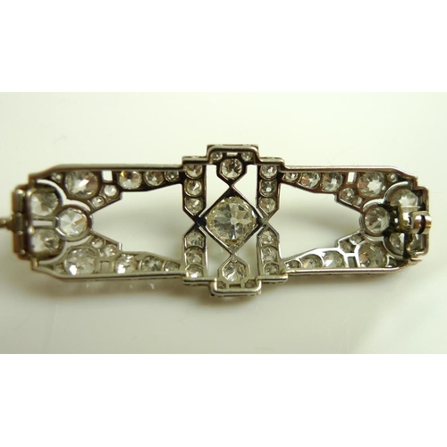 940 - An Art Deco diamond brooch, of stylised geometric design, the central diamond of approximately 0.75c... 